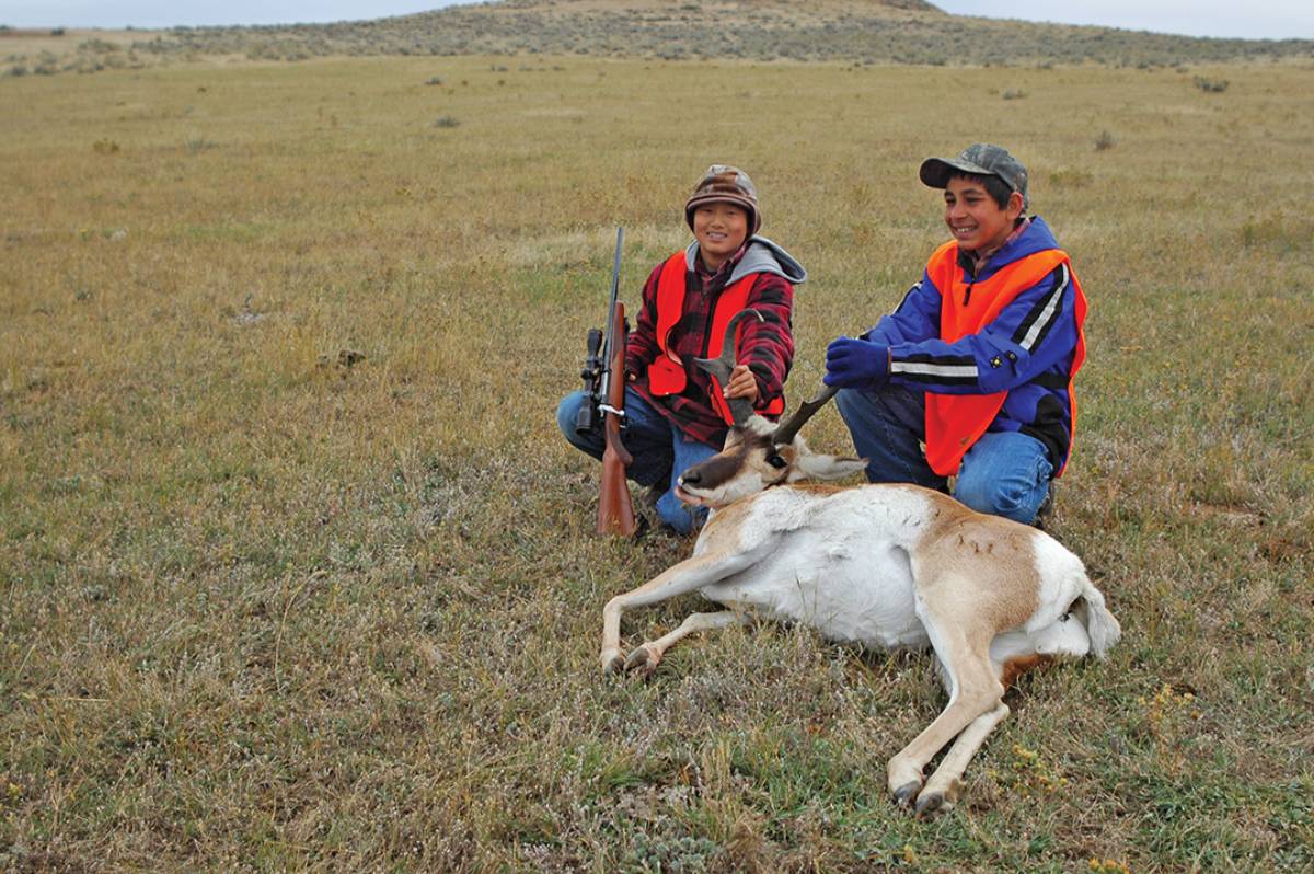 Jack’s sons smile for a photo with his eldest’s first pronghorn, the result of an impromptu interception.